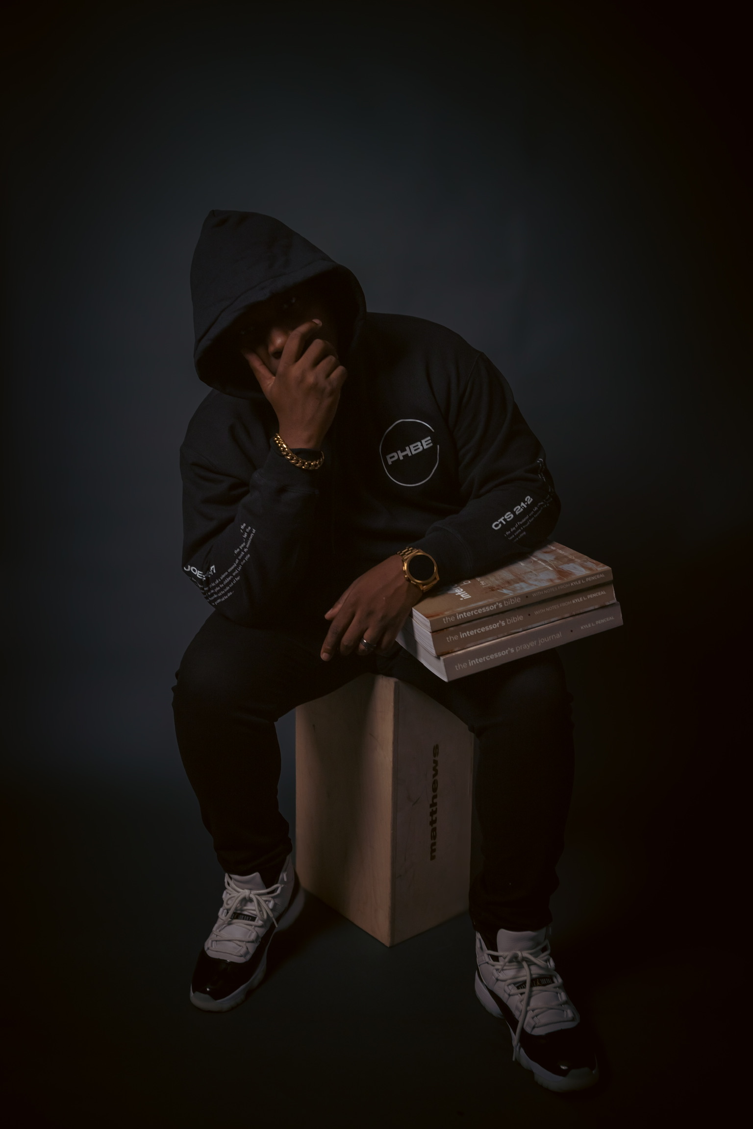 Kyle L. Penceal seated with books